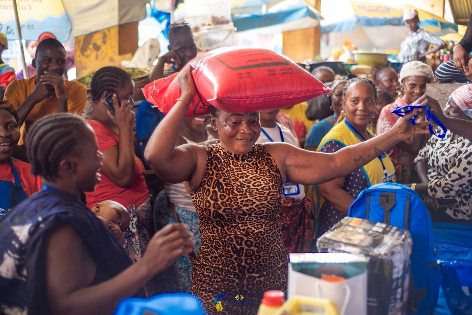 A winner carries her prize through Kroo Town Road Market